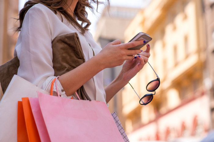 woman checking daily deals on smartphone