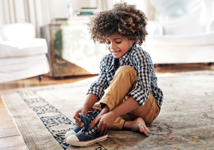 boy is trying on shoes