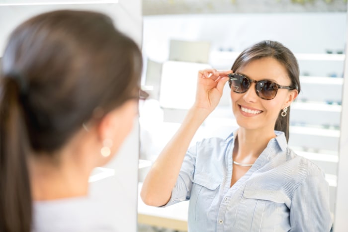 Woman buying sunglasses at the optician's shop