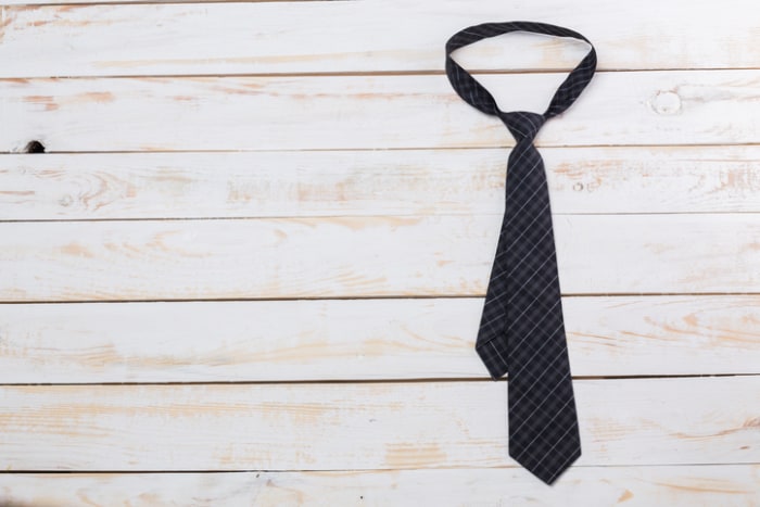 Fathers day composition, tie laid on wooden floor.