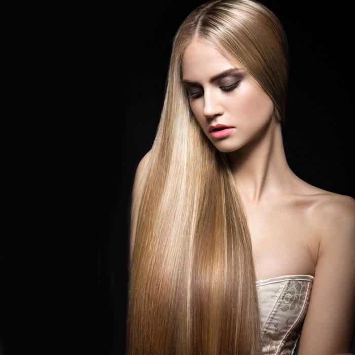 Beautiful blond girl with perfectly smooth hair and classic make-up.