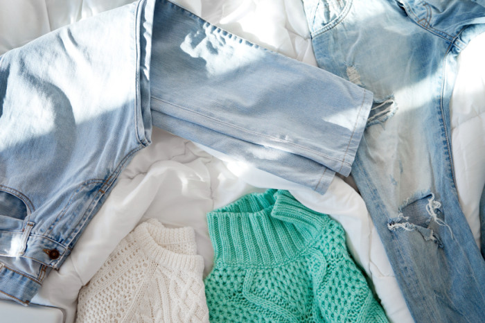 Female outfit laid out on bed